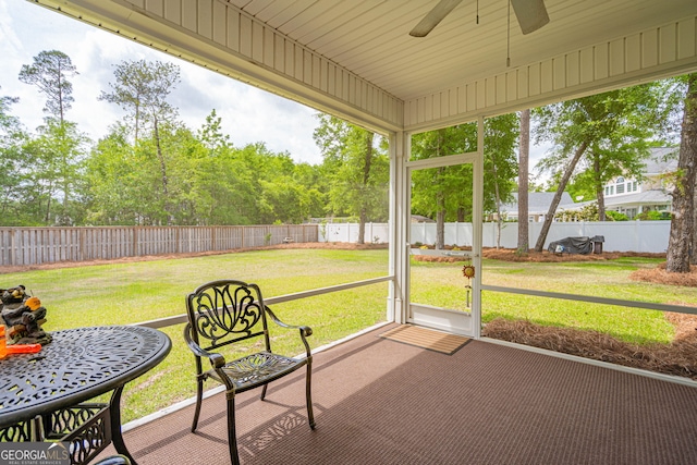 sunroom / solarium featuring ceiling fan