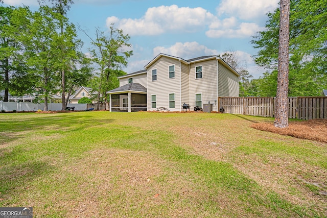 rear view of property featuring a sunroom