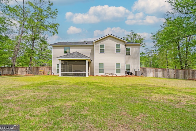 rear view of property with a sunroom, central AC unit, and a shingled roof