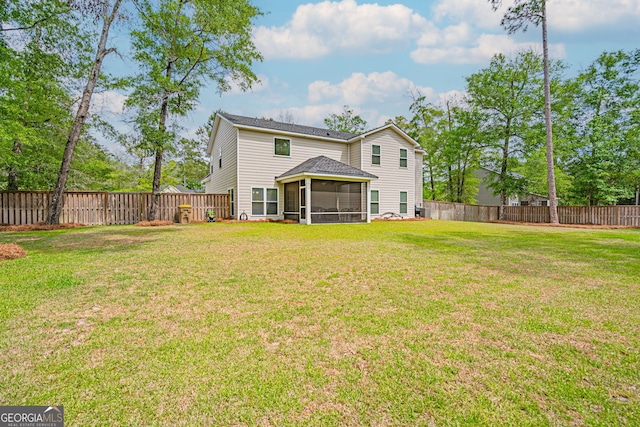 back of house with a sunroom and a shingled roof