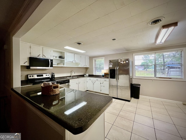 kitchen with stainless steel appliances, a sink, light tile patterned floors, a peninsula, and open shelves