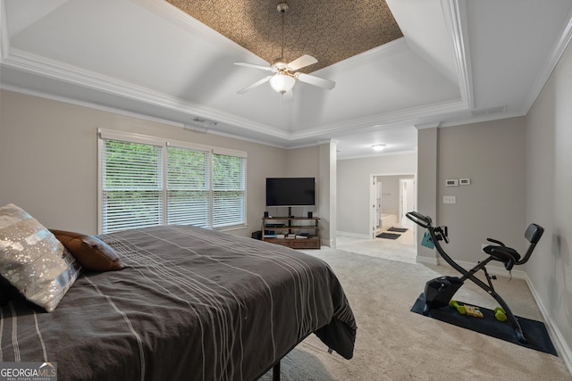 6217 Millstone Trl, Douglasville, GA 30135 - carpeted bedroom featuring a tray ceiling, ornamental molding, connected bathroom, ceiling fan, and baseboards