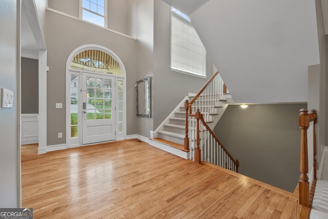 6217 Millstone Trl, Douglasville, GA 30135 - foyer entrance featuring wood finished floors, a towering ceiling, and stairs