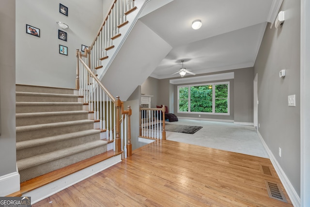 6217 Millstone Trl, Douglasville, GA 30135 - stairs with a ceiling fan, wood finished floors, crown molding, and baseboards