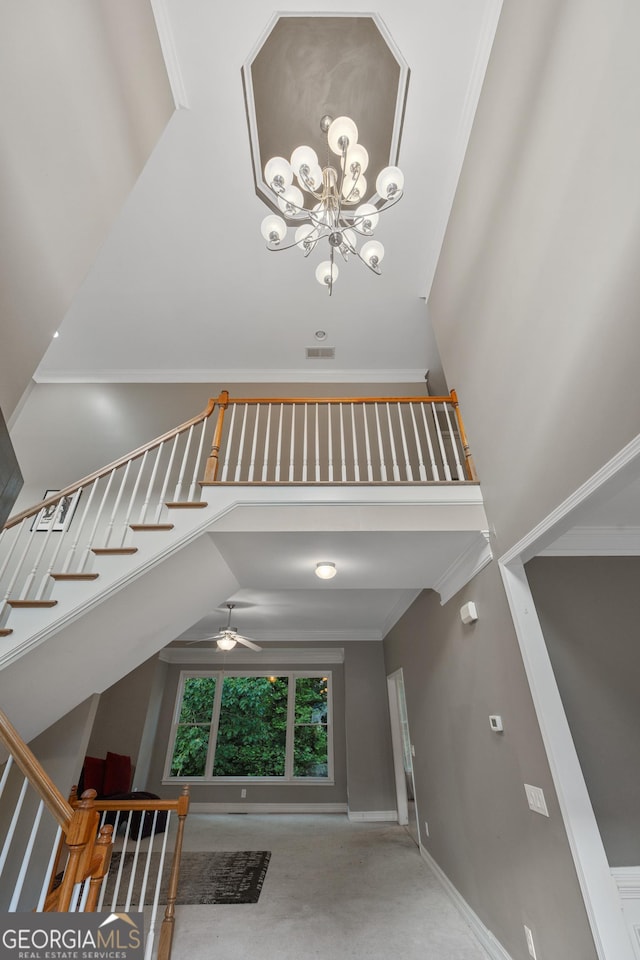 6217 Millstone Trl, Douglasville, GA 30135 - unfurnished living room featuring a high ceiling, carpet flooring, ceiling fan, a chandelier, and crown molding