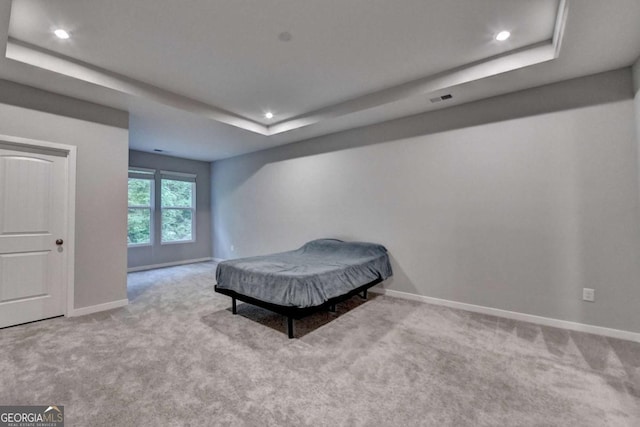 bedroom featuring a raised ceiling, carpet, baseboards, and recessed lighting