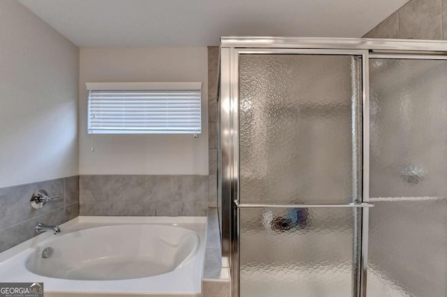 full bath featuring a stall shower and a bath