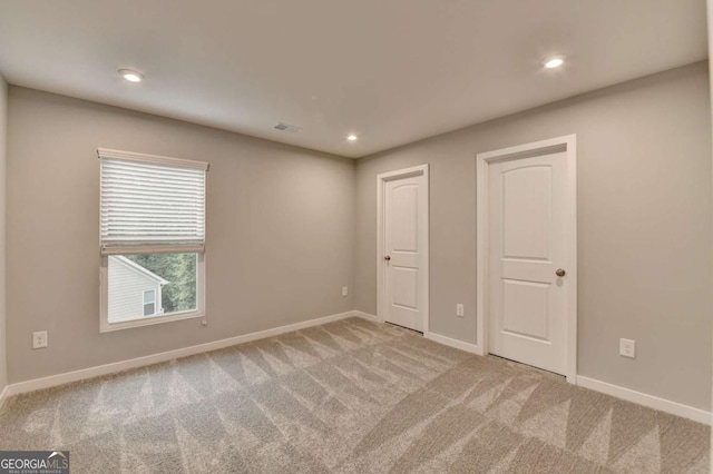 unfurnished room with carpet floors, baseboards, and recessed lighting