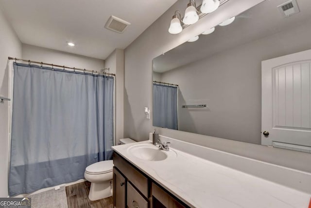 full bath featuring toilet, wood finished floors, vanity, and a shower with shower curtain
