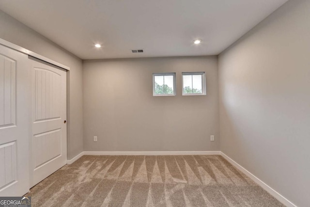 unfurnished bedroom with carpet flooring, baseboards, recessed lighting, and a closet