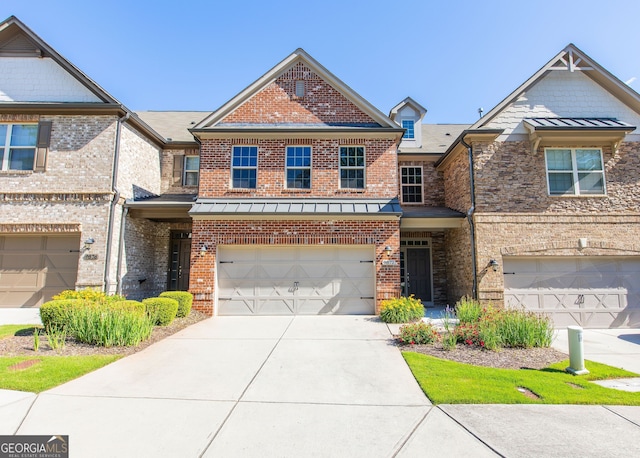 9872 Cameron Parc Cir, Johns Creek, GA 30022 - view of front of home featuring an attached garage, driveway, brick siding, a standing seam roof, and metal roof