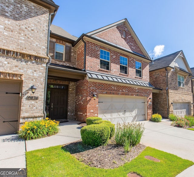 9872 Cameron Parc Cir, Johns Creek, GA 30022 - view of front of house featuring brick siding, an attached garage, and concrete driveway