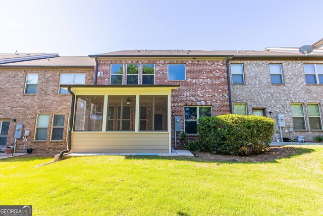 9872 Cameron Parc Cir, Johns Creek, GA 30022 - back of house with a sunroom, a lawn, and brick siding