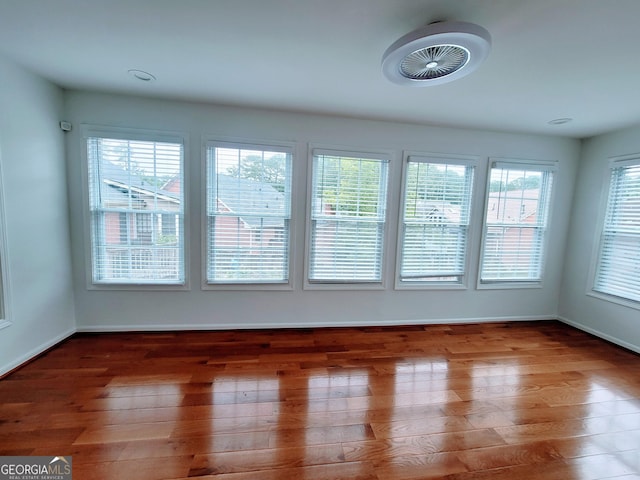 empty room with wood finished floors and baseboards