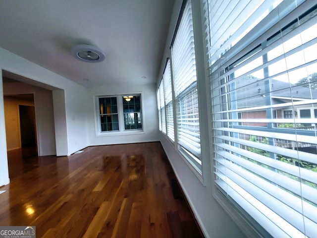 unfurnished room with wood finished floors