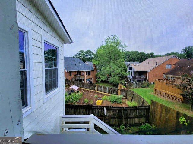 fenced backyard with a residential view