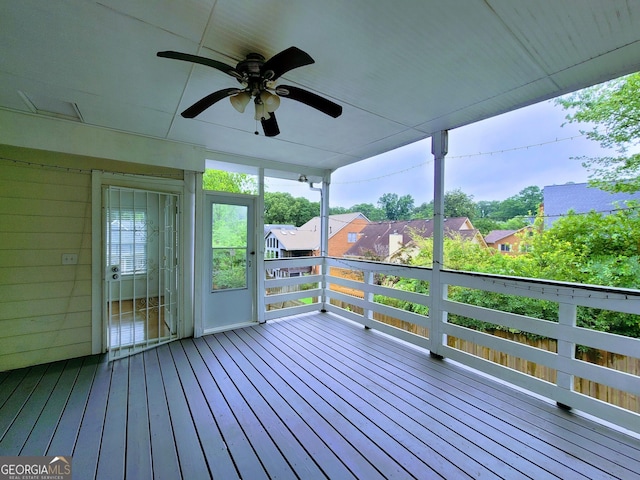 wooden terrace with a ceiling fan and a residential view