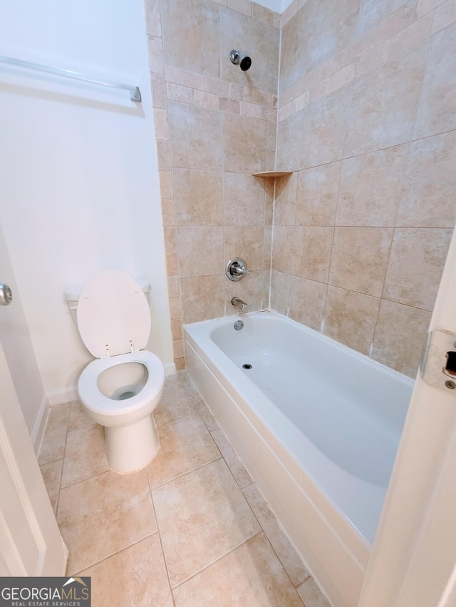 bathroom with baseboards, tile patterned floors, toilet, and shower / tub combination