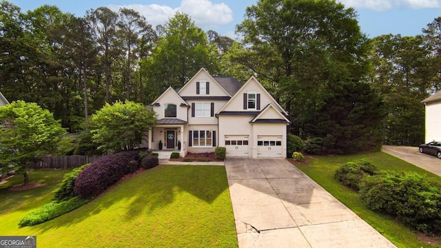 view of front of home with driveway, a standing seam roof, a garage, and metal roof