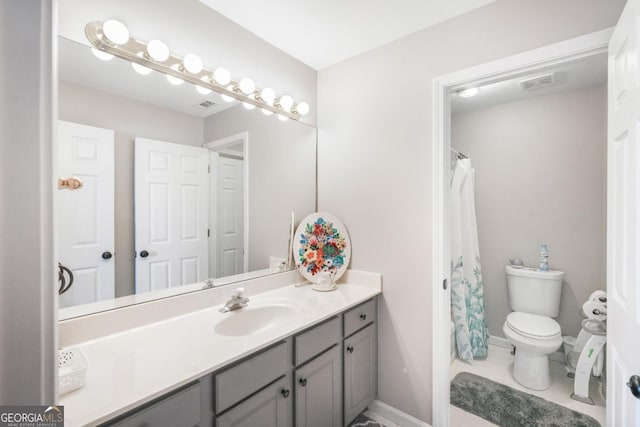 bathroom featuring toilet, vanity, tile patterned flooring, baseboards, and curtained shower