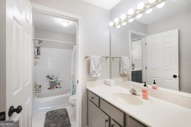 bathroom featuring toilet, vanity, shower / bath combo with shower curtain, and tile patterned floors