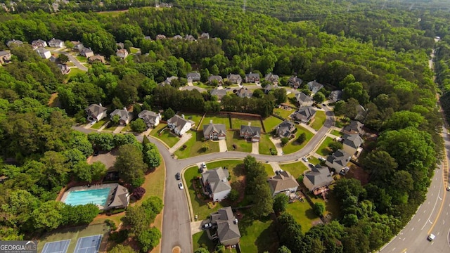 aerial view of residential area featuring a heavily wooded area