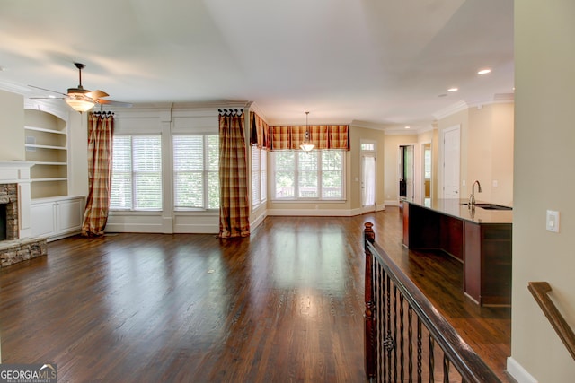 7520 Ledgewood Way, Suwanee, GA 30024 - unfurnished living room featuring a ceiling fan, a fireplace, ornamental molding, baseboards, and dark wood finished floors