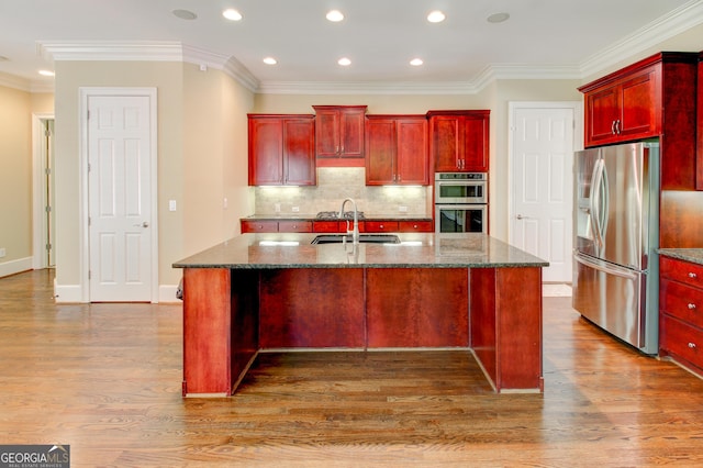 7520 Ledgewood Way, Suwanee, GA 30024 - kitchen with dark brown cabinets, stainless steel appliances, recessed lighting, dark stone counters, and wood finished floors