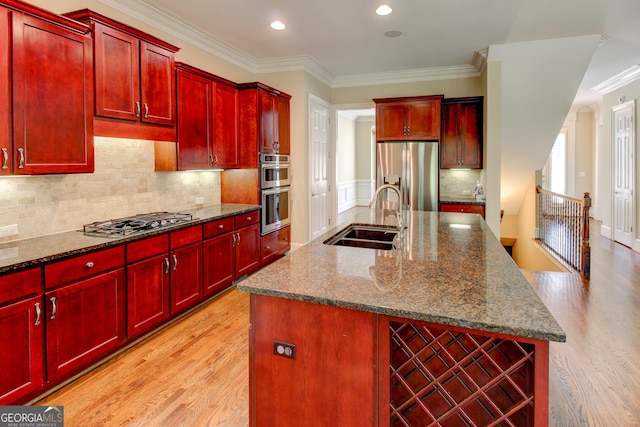 7520 Ledgewood Way, Suwanee, GA 30024 - kitchen with dark brown cabinets, stainless steel appliances, light wood-style floors, crown molding, and an island with sink
