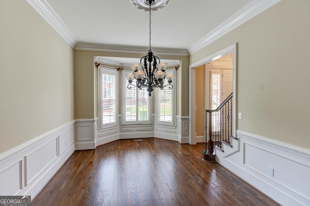 7520 Ledgewood Way, Suwanee, GA 30024 - unfurnished dining area featuring a chandelier, plenty of natural light, ornamental molding, wainscoting, and stairs