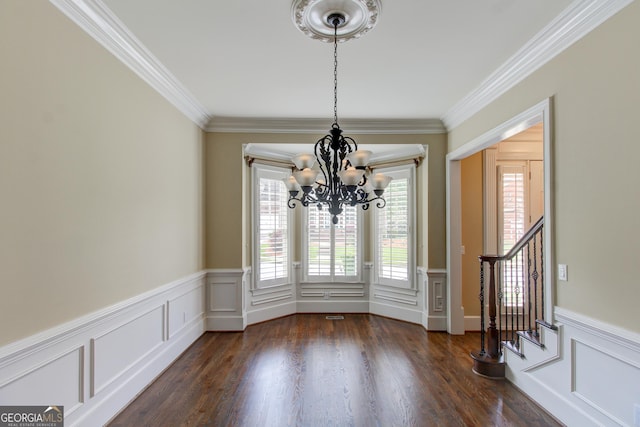 7520 Ledgewood Way, Suwanee, GA 30024 - unfurnished dining area with a chandelier, crown molding, stairs, wainscoting, and dark wood-style flooring