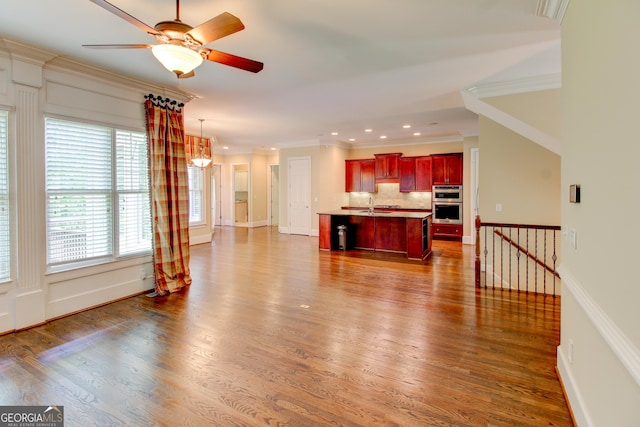 7520 Ledgewood Way, Suwanee, GA 30024 - unfurnished living room featuring crown molding, a ceiling fan, dark wood-type flooring, and recessed lighting