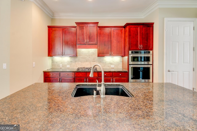 7520 Ledgewood Way, Suwanee, GA 30024 - kitchen featuring reddish brown cabinets, a sink, double oven, tasteful backsplash, and ornamental molding