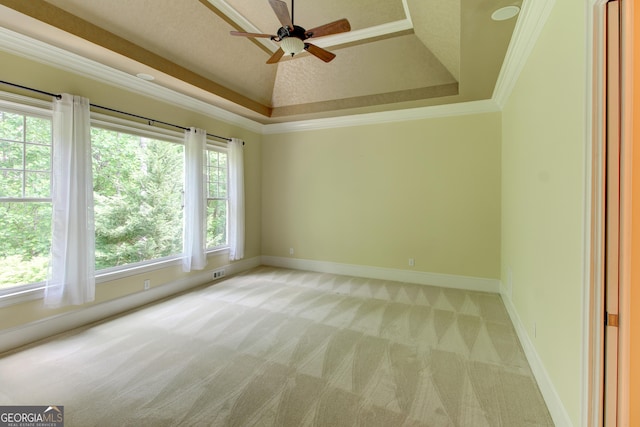 7520 Ledgewood Way, Suwanee, GA 30024 - empty room featuring light colored carpet, a ceiling fan, a raised ceiling, and crown molding
