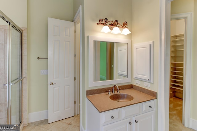 7520 Ledgewood Way, Suwanee, GA 30024 - bathroom with a walk in closet, a shower stall, and vanity