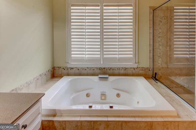 7520 Ledgewood Way, Suwanee, GA 30024 - bathroom with a tub with jets and vanity