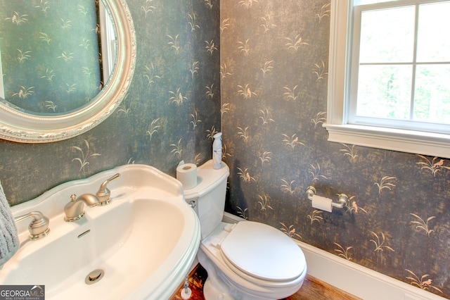 7520 Ledgewood Way, Suwanee, GA 30024 - half bath featuring a sink, toilet, and wood finished floors