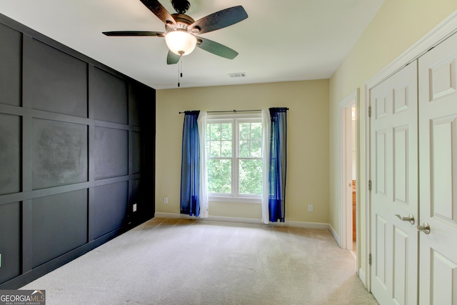 7520 Ledgewood Way, Suwanee, GA 30024 - unfurnished bedroom featuring light carpet, a ceiling fan, and a closet