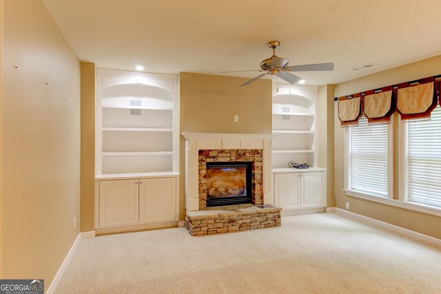 7520 Ledgewood Way, Suwanee, GA 30024 - unfurnished living room featuring ceiling fan, built in features, carpet floors, and a fireplace