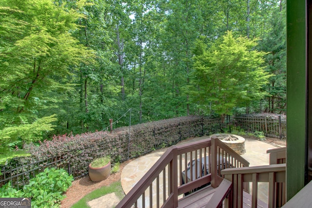 7520 Ledgewood Way, Suwanee, GA 30024 - wooden terrace featuring an outdoor fire pit, a patio area, and a wooded view