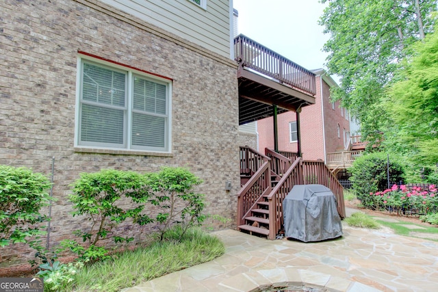 7520 Ledgewood Way, Suwanee, GA 30024 - doorway to property featuring a patio area, brick siding, and a balcony