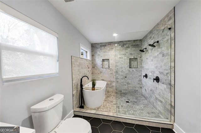 1571 Blvd Lorraine, Atlanta, GA 30311 - bathroom featuring tile patterned floors, toilet, tiled shower, and a freestanding bath
