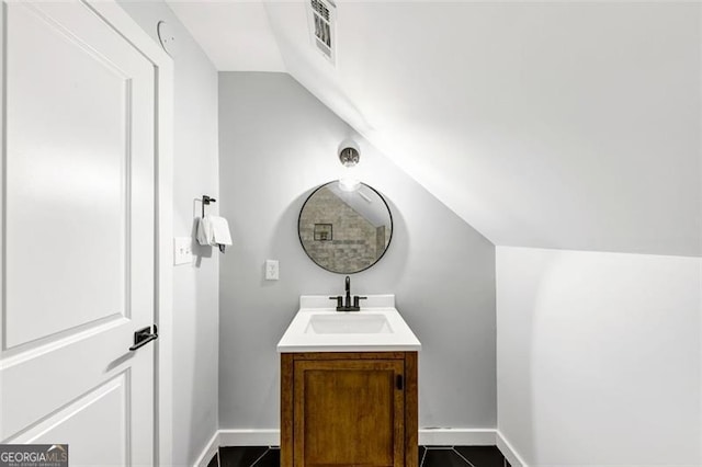 1571 Blvd Lorraine, Atlanta, GA 30311 - bathroom featuring vaulted ceiling, vanity, baseboards, and tile patterned flooring