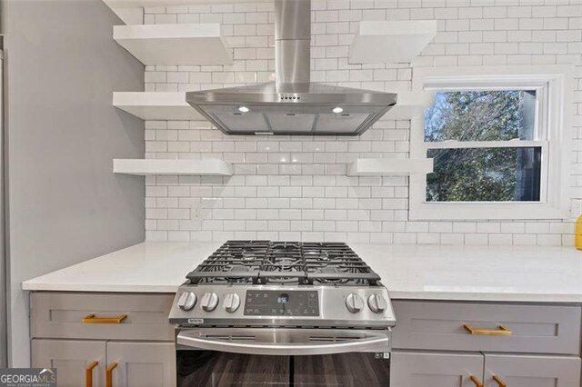 1571 Blvd Lorraine, Atlanta, GA 30311 - kitchen with open shelves, gray cabinets, stainless steel range with gas stovetop, and wall chimney exhaust hood