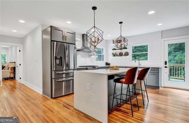 1571 Blvd Lorraine, Atlanta, GA 30311 - kitchen featuring stainless steel fridge with ice dispenser, wall chimney exhaust hood, tasteful backsplash, light countertops, and recessed lighting