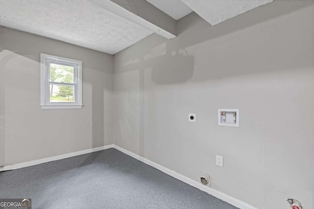 laundry room featuring washer hookup, hookup for an electric dryer, baseboards, and a textured ceiling