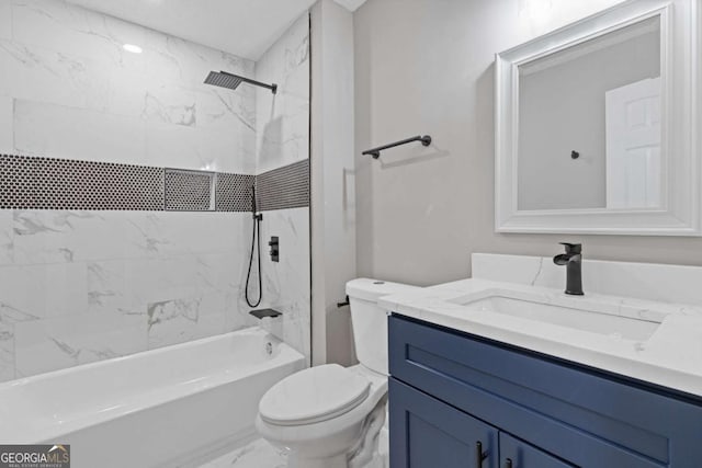 bathroom featuring marble finish floors, toilet, vanity, and bathtub / shower combination