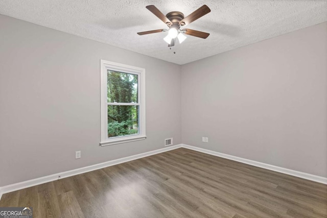 unfurnished room with wood finished floors, a textured ceiling, ceiling fan, and baseboards