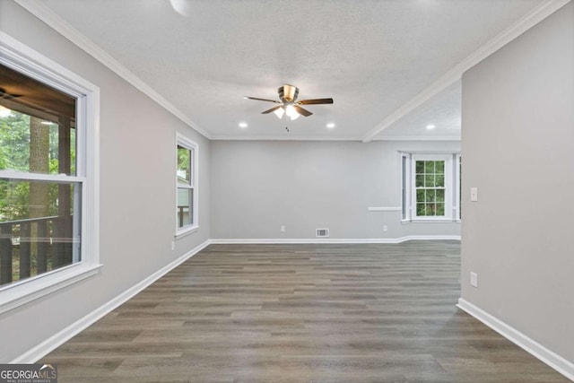 spare room with ceiling fan, recessed lighting, wood finished floors, baseboards, and ornamental molding