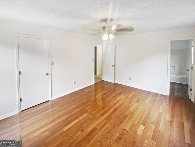 2325 Sebring Ct SW, Marietta, GA 30064 - unfurnished bedroom featuring light wood-style floors, baseboards, ensuite bathroom, and a ceiling fan
